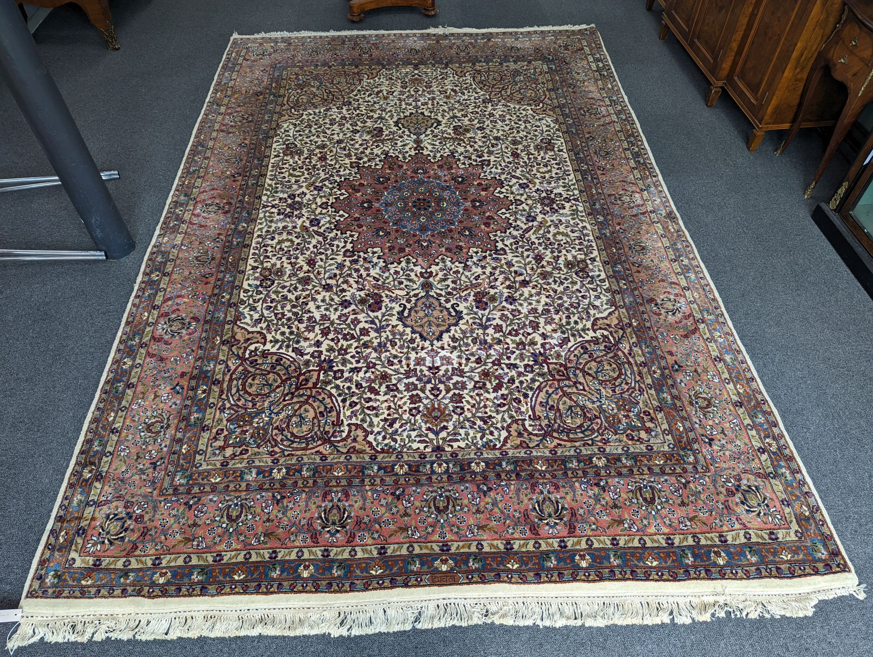 A Ghoum ivory ground carpet, 313 x 212cm